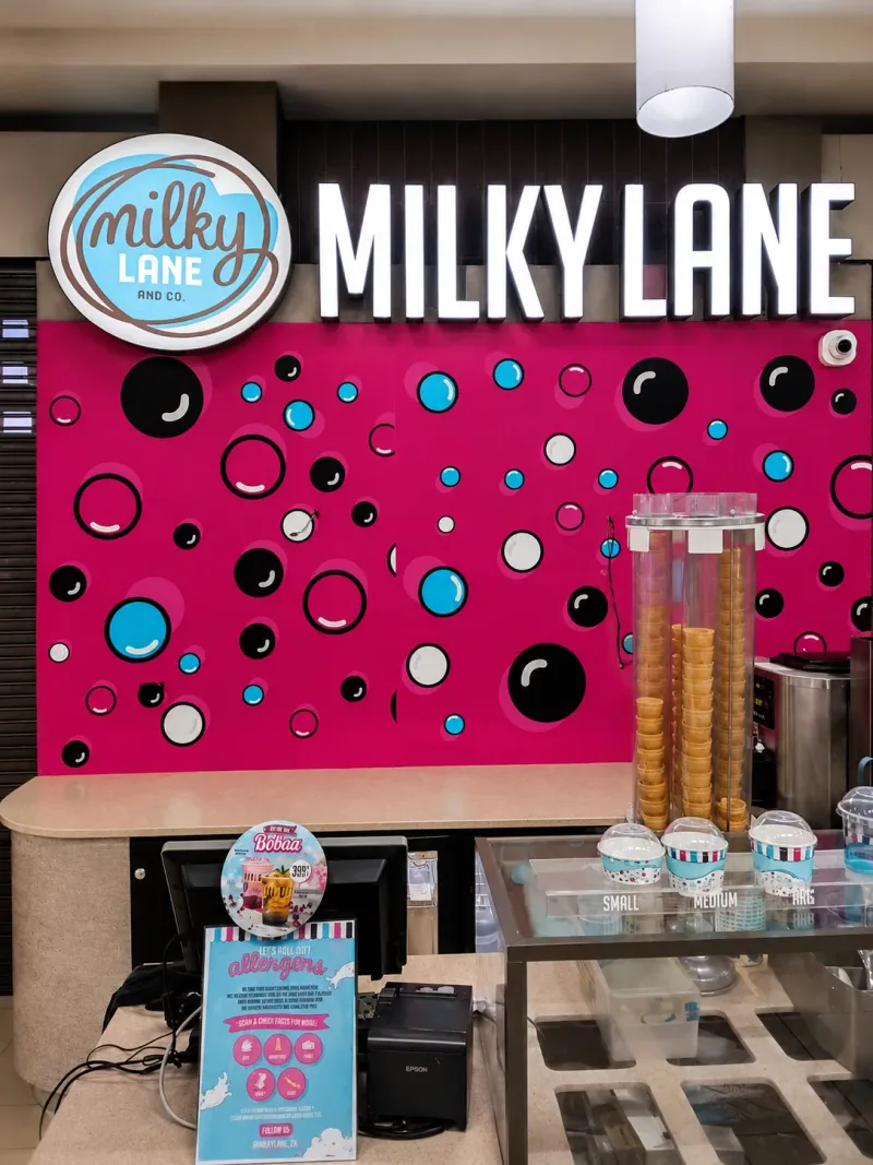 Milky Lane branded wallpaper and mural graphics and 3D fabricated sign manufactured and installed by Sign Image — project photo 3